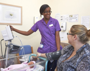 midwife with patient and baby on ward